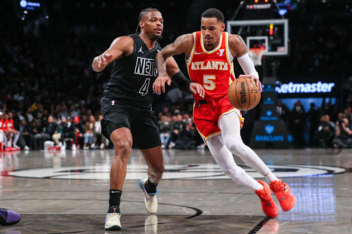 Feb 29, 2024; Brooklyn, New York, USA; Atlanta Hawks guard Dejounte Murray (5) moves past Brooklyn Nets guard Dennis Smith Jr. (4) in the fourth quarter at Barclays Center. Mandatory Credit: Wendell Cruz-USA TODAY Sports